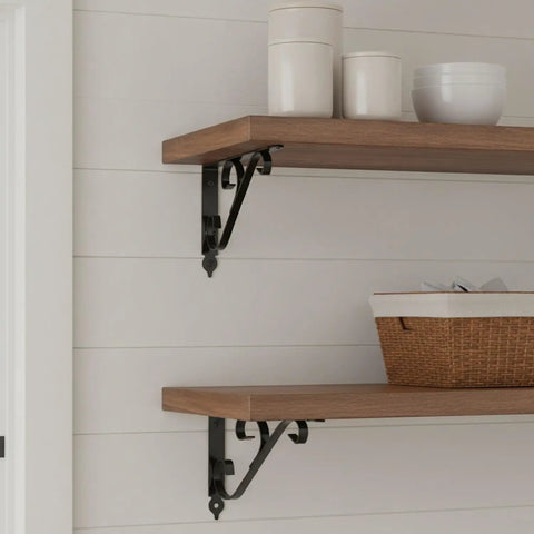 Wooden shelf with ornaments supported by Carbon Steel L-Shaped Shelf Bracket Heavy Duty Wall Mount Support For Floating Shelves.