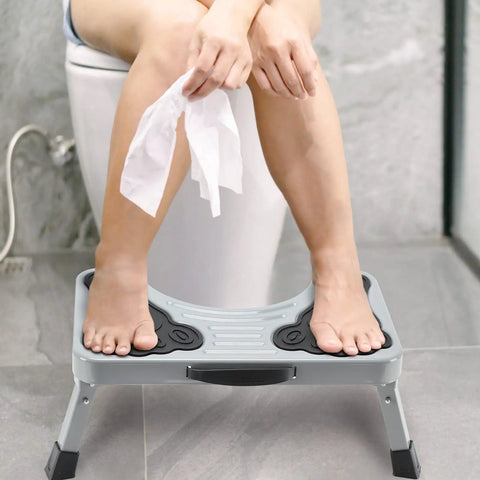 Person using 7 Inch Metal Toilet Stool Collapsible Potty Stool for Adults and Kids Elevates Your Feet for Natural Pooping Posture Reducing Strain