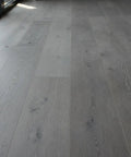 Heritage Gray Reactive Water Based VOC Free Interior Wood Stain 55 Gallon Tank applied on smooth gray wooden flooring.