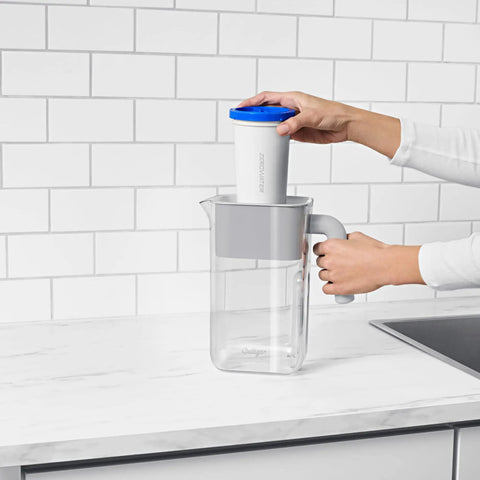 Person inserting ZeroWater Technology Replacement Filter 3-Pack, Pro Grade 5-Stage Advanced Water Filtration System into pitcher.