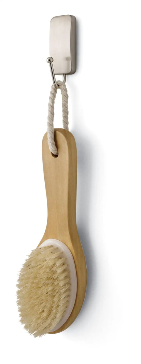 Small Satin Nickel Bath Hook With Water Resistant Strips Holds Up To 1 Lb No Tools Needed Super Easy Install For Damage Free Bathroom Organization In The Shower And Around The Sink Anywhere In Your Bathroom holding a brush.