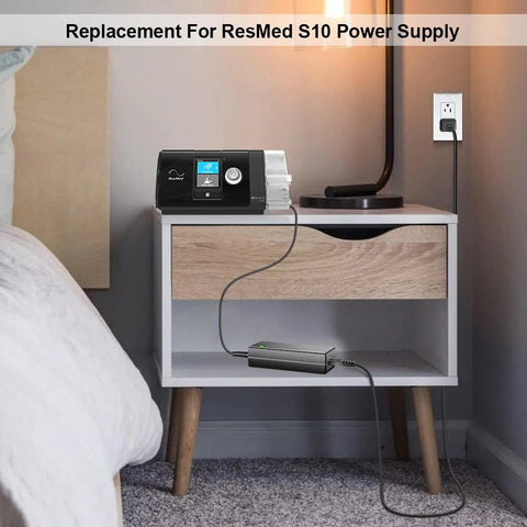 Front view of ResMed AirSense 10 power supply on a nightstand, with 24V AC adapter and external power brick.