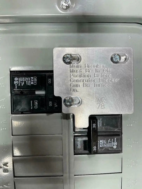 Close-up of Generator Interlock Kit With Electric Start For 100 Amp Panels Compatible With Siemens Eaton Or ITE Billet Aluminum Made In USA Includes Installation Instructions Mounting Hardware Drill Bit And Panel Stickers installed on panel