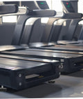 Four Piece Adjustable Treadmill Levelers With Non Slip Swivel Base stabilizing treadmills on a home gym floor.