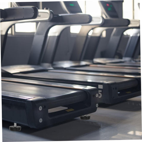 Four Piece Adjustable Treadmill Levelers With Non Slip Swivel Base stabilizing treadmills on a home gym floor.