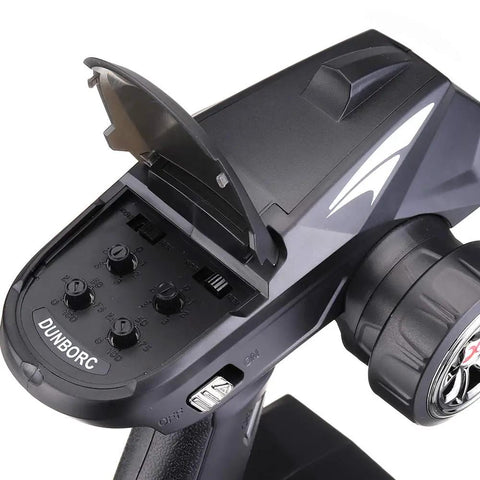 Close-up of the X4 4CH RC Radio System Transmitter for Cars Boats Tanks, showing control knobs and battery compartment.