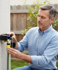 Man installing Hardcore Gate Valve Locking Device With Password Lock No Install Required Sturdy Metal Black External Hose Lock on faucet