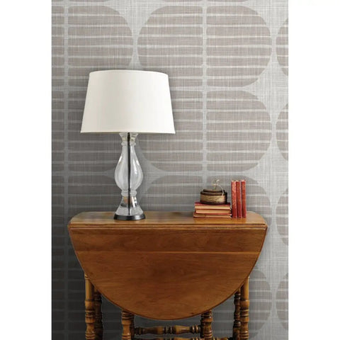 Super Sleek Geometric Stripe Vinyl Wallpaper Shows Off Subtle Leather Texture And Delivers Knockout Durability For Heavy Traffic Commercial Spots Or Wild Home Rebounds Featuring Type Ii Sturdiness And Custom Prints That Bring The Real Deal Vibes on a beige wall with a lamp and books.
