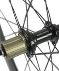 Close-up of a hub on the Beast 50mm Carbon Basalt Braking Surface Clincher Road Wheelset 700c with Matte 3k Finish Toray T700 Fibers.