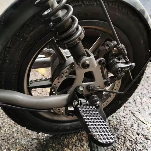 Rugged Durable Aluminum Alloy Scooter And E-Bike Foot Pegs, 4.7 Inch Length With Anti Slip Textured Surface, installed on rear wheel.