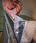 Conduit Locknut Wrench Set in Compact Alloy Steel Design With Magnetic Storage Built For Tight Spots includes one-half inch wrench being used