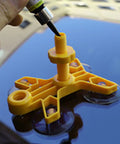 Close-up of Windshield Crack Repair Kit for Cars in use on auto glass, showing resin application with yellow applicator base.