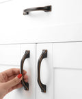 Oil Rubbed Bronze Cabinet Pulls 3 Inch 76mm 10 Pack Brushed Bronze Handles installed on white kitchen drawers