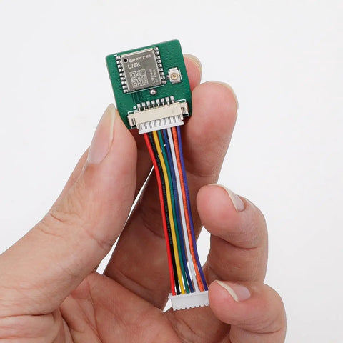 Hand holding Ultra Low Power GNSS GPS Module For IoT Gear 2.8V To 4.3V, 18mA with colored wires, compact design