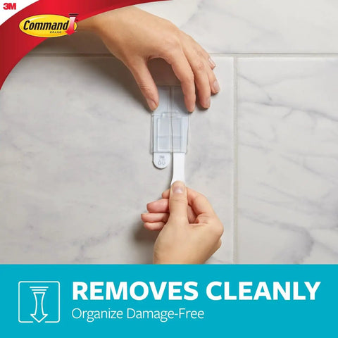 Bathroom Accessory Organizer With Two Medium Water Resistant Strips Satin Nickel Finish Holds Up To 2 Lb No Tools Needed Damage Free Stick On Wall Mount Keeps Counter Clutter Free being removed from wall with hands.