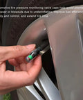 Hand installing 8 Pack Tire Pressure Monitor Valve Stem Caps With 3 Color Eye Alert onto car tire