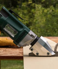 Pro Grade Heavy Duty Electric Fiber Cement Siding Cutter With Six Point Five Amp Motor cutting through fiber cement board.