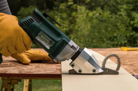 Pro Grade Heavy Duty Electric Fiber Cement Siding Cutter With Six Point Five Amp Motor cutting through fiber cement board.