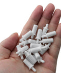 Twenty Piece Collection Of Spring Loaded Shutter Louver Replacement Pins Providing A No Sweat Upgrade For Fast Air Vent Repairs Using Heavy Duty Matte White Plastic Components in a hand.