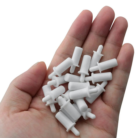 Twenty Piece Collection Of Spring Loaded Shutter Louver Replacement Pins Providing A No Sweat Upgrade For Fast Air Vent Repairs Using Heavy Duty Matte White Plastic Components in a hand.