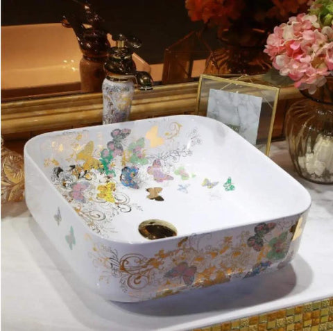 Top Shelf Handmade Ceramic Bathroom Sink Featuring A Super Sleek Butterfly Design Countertop Vessel Wash Basin in white with gold detailing.