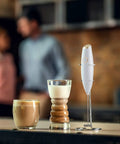 Handheld Milk Frother And Electric Whisk With 19000 RPM Power Includes Recipe Book And Stainless Steel Stand White And Gold Finish Perfect For Lattes Cappuccinos And More displayed with coffee drinks