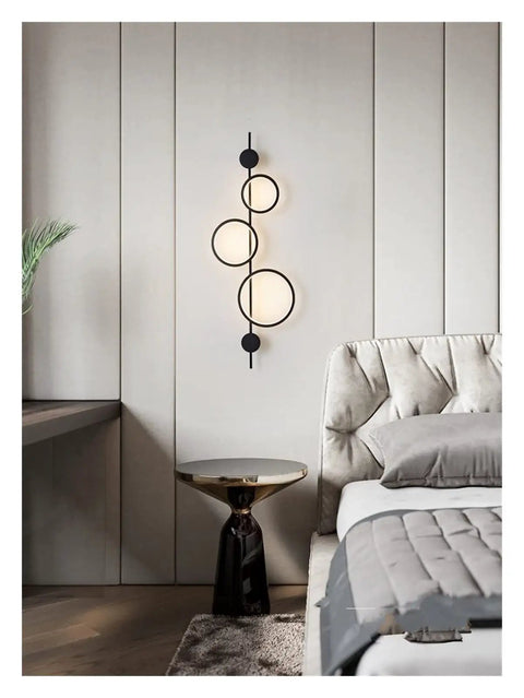 Top Shelf Modern Wall Sconce With Straight Fire Led Glow And Hella Sturdy Iron Frame Perfect For Bedroom Bedside Or Tv Backdrop Ambiance Easy Surface Mount And Super Durable Daily Lighting mounted beside a bed, featuring black iron and round LED lights.