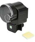 Slick Install Automatic Fish Feeder For Aquarium Battery Operated With Adjustable Portion Control and Vacation Timer showing feeder with wall clip.