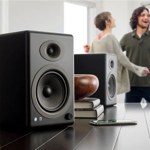 Powered Bookshelf Speakers For Turntables, Vinyl Setup And Streaming - 150W Of Room-Filling Crisp Kickin' HiFi Audio in bamboo finish on table