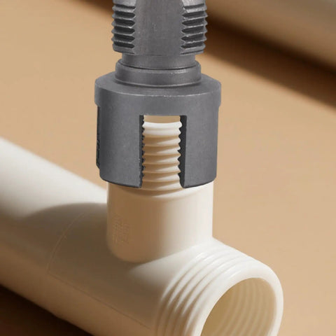 Heavy Duty Integrated Internal And External Pipe Threading Tool Set With 1/2" 3/4" 1" Dies on white plastic pipe joint.