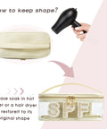 Clear SPF 50 Makeup Bag With Metal Zipper For Sunscreen And Travel Essentials shown with hair dryer for shape restoration
