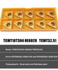 Ten TCMT32.51 carbide external turning inserts in a yellow plastic holder
