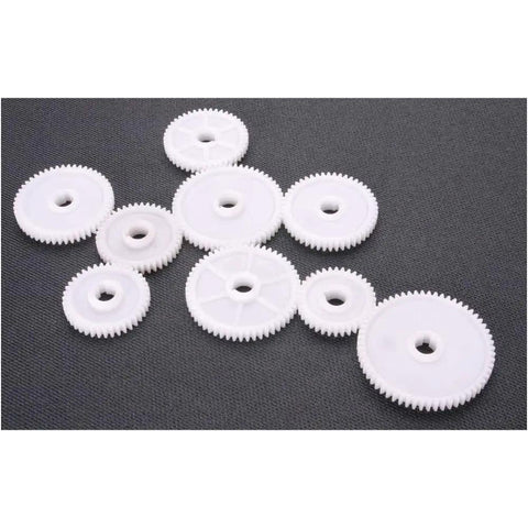 9 White plastic gears of varying sizes for precision applications in machinery, compatible with 6 By 10 Inch Mini Metal Lathe Runs Smooth As Silk Precision Threading.