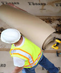 Worker carrying X Board Seam Tape Tan 1.89 Inch By 164 Foot Contractor Grade Adhesive for Quick Seam Sealing and Surface Protection