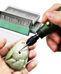 Person using 90 Pc Diamond Burr Bits Kit For Engraving And Carving On Glass Gemstone Metal with rotary tool on stone