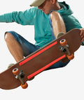 Skater using Abs Rail Guards For Longboard And Electric Skateboard with impact resistant construction in orange.