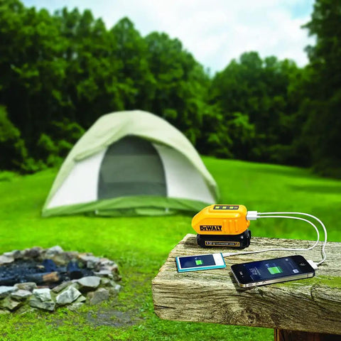 12V And 20V Max USB Charger With Two Ports And State Of Charge Indicator in use, charging phones outdoors near a tent.