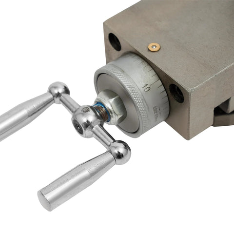 AT300 metal lathe tool post close-up with gray dial and chrome lever handles mounted on a gray machining block