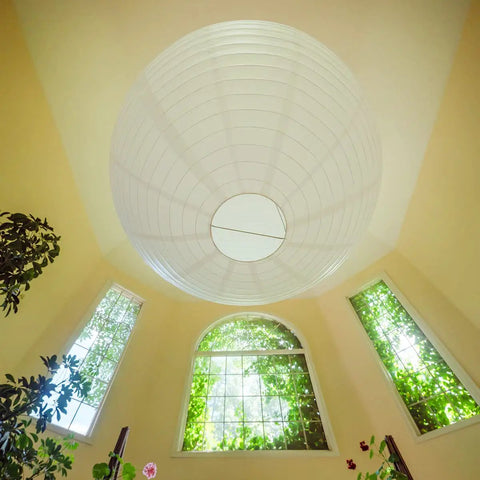 Jumbo White Paper Lantern 30 Inch Indoor Decor For Large Rooms Elegant Reusable Accordion Style Lighting Ideal For Parties And Events Ceiling Decor Showstopper Vibe Party Ready hanging from ceiling in a bright room.