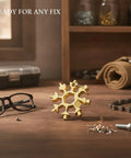 Snowflake-Shaped Compact Multi Tool Wrench for Eyewear, Bike, and Camping Repairs on wooden table with glasses and chain.