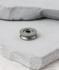 20 Pack V623ZZ V Groove Sealed Ball Bearings 12X3X4MM For CNC Routers And Linear Guide Tracks on gray stone surface.