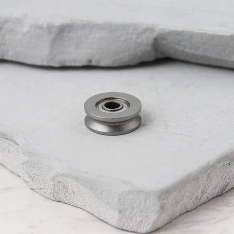 20 Pack V623ZZ V Groove Sealed Ball Bearings 12X3X4MM For CNC Routers And Linear Guide Tracks on gray stone surface.