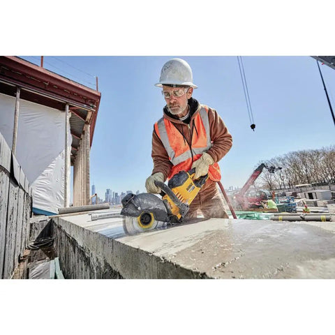 Worker cutting concrete with Flexvolt 9 Inch Diamond Cutting Wheel For Masonry And Concrete With Seven Eighths Inch Arbor 6600 Max RPM