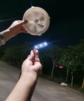 Person holding a Dual-Mode Portable Wind And Water Turbine Generator For Outdoor Power Small Hydroelectric Micro Turbine at night.