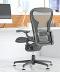 Heavy Duty Low Profile Desk Chair Casters With A Grippy Grip Ring Base under office chair in modern workspace, featuring gray mesh back.