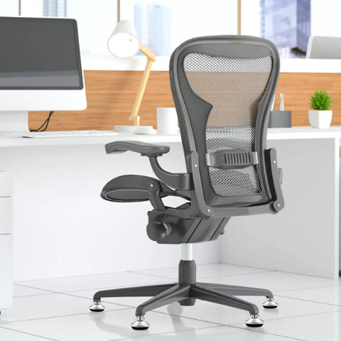Heavy Duty Low Profile Desk Chair Casters With A Grippy Grip Ring Base under office chair in modern workspace, featuring gray mesh back.