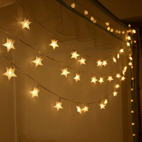 Warm White 50 LED Five Point Star Fairy Lights With Remote Control Battery Powered String Lights glowing indoors