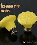 Totally Slick Yellow Ceramic Cabinet Knobs Featuring Dang Cute Embossed Floral Patterns Vintage Drawer Handles And Furniture Pulls For Kitchen Makeover Twenty Piece Pack. Close-up of yellow ceramic knobs with floral design.