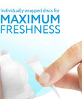 Hand opening a steam mop fragrance disc in Spring Breeze scent for fresh floors compatible with Bissell models, 15 pack.