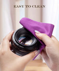 Purple microfiber camera lens cleaning cloth being used to wipe a lens (close-up)